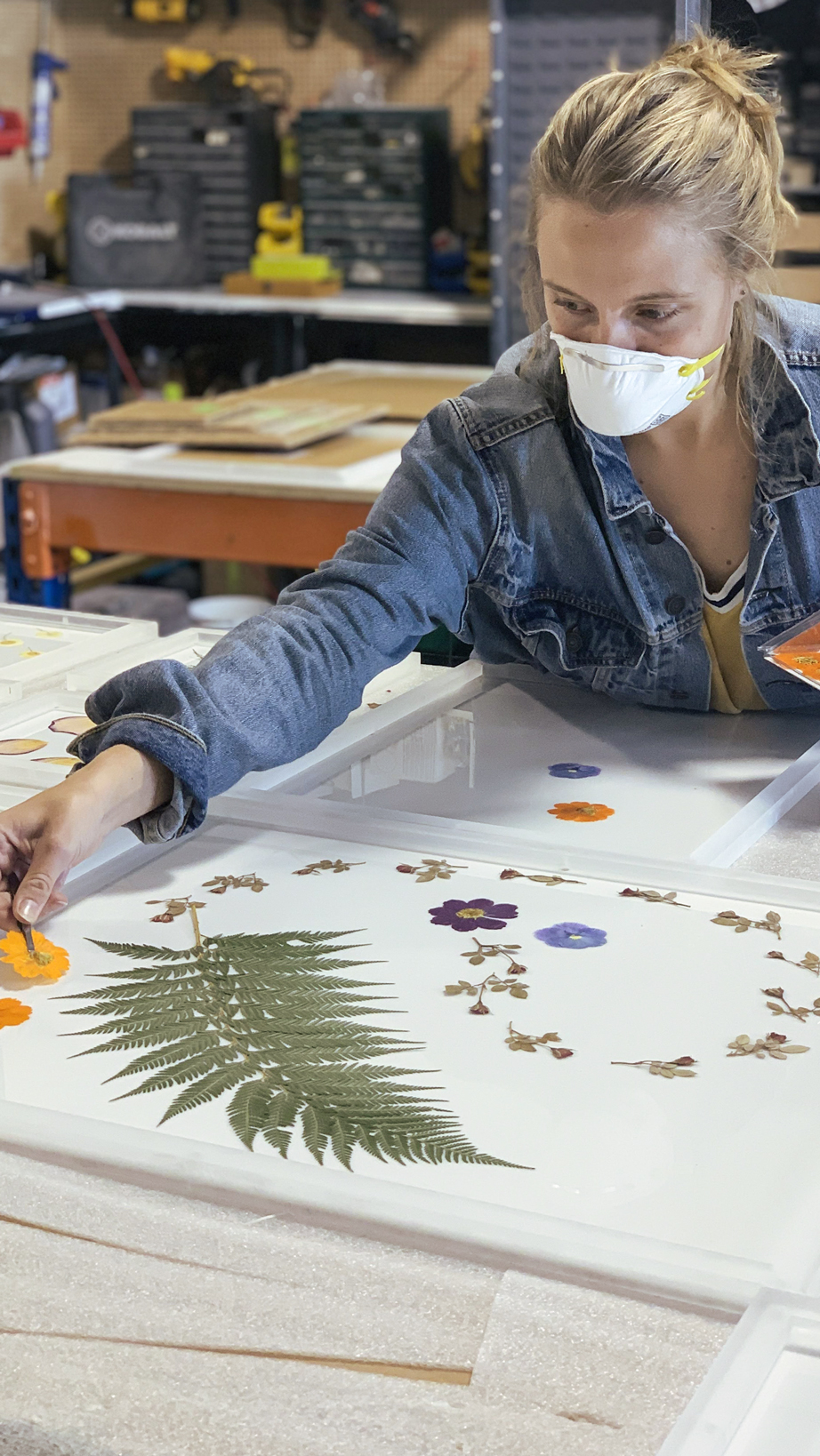 Designer pressing florals and leaves for an installation