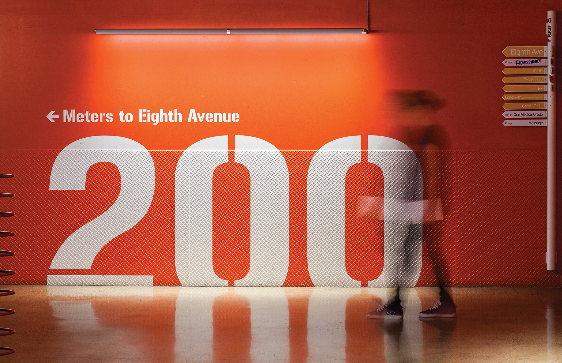 Large typographic directional on wall for Taconic Investment Partners.
