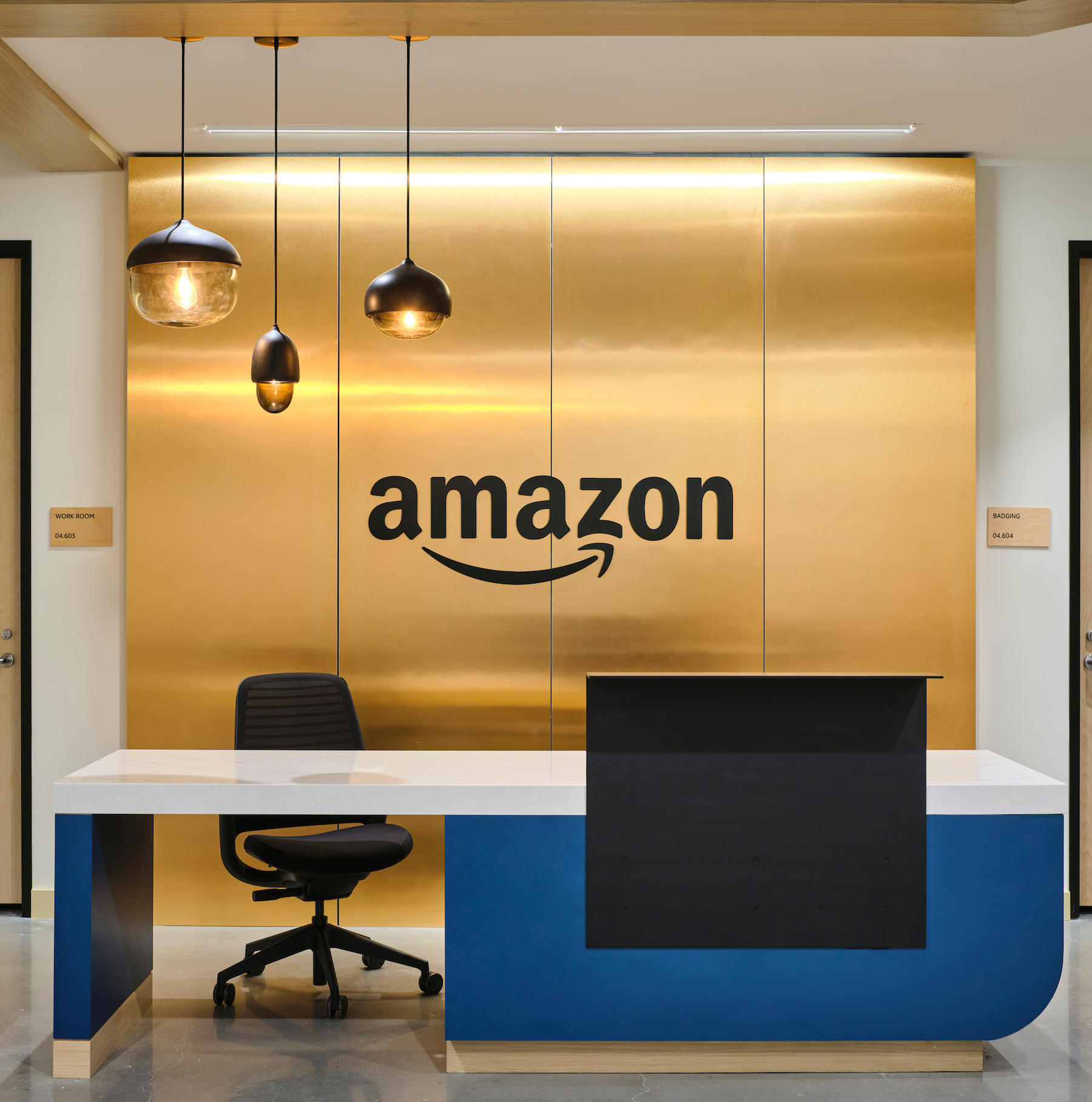 Amazon logo on wall behind desk