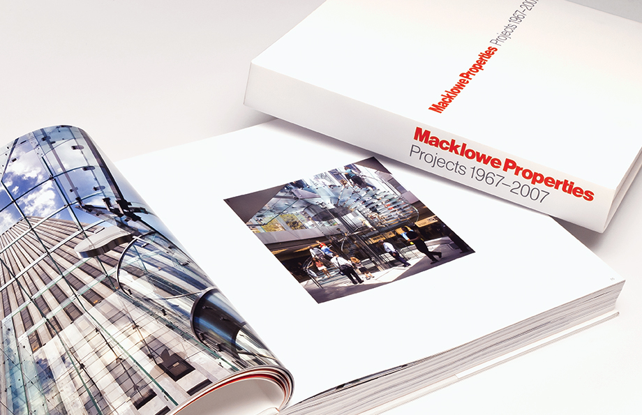 Macklowe Properties Project book. One book opened to a spread with an additional book on top displaying the cover and spine.