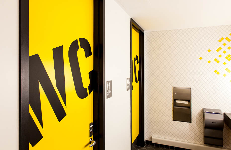 Environmental graphics for New York on Two Wheels. Typographic treatment on bathroom doors.