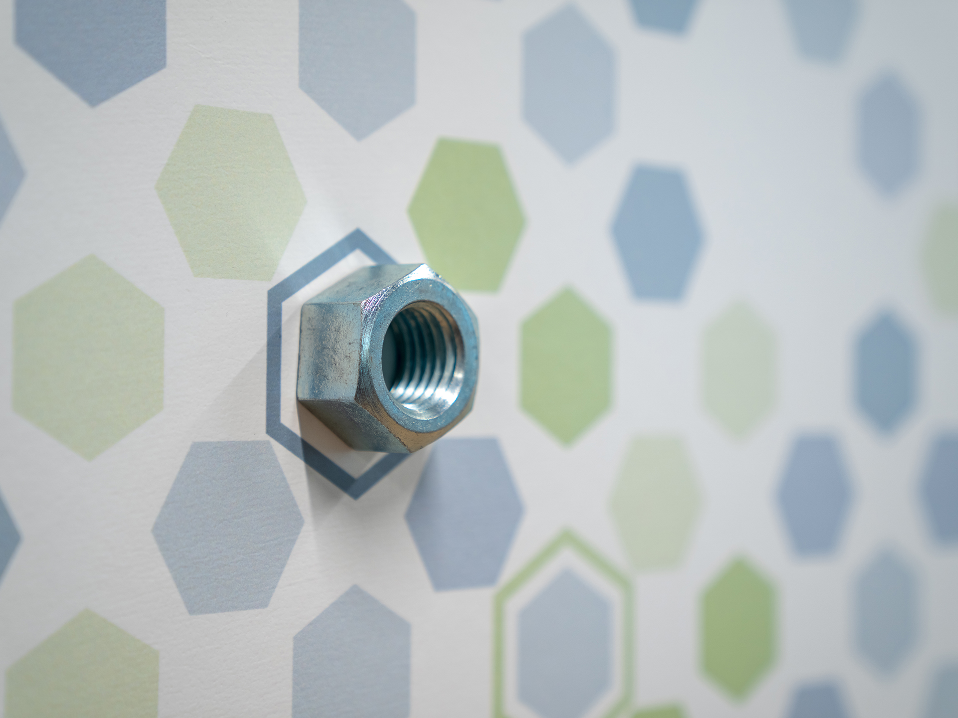 Wall graphic with colorful hexagons and hex nuts