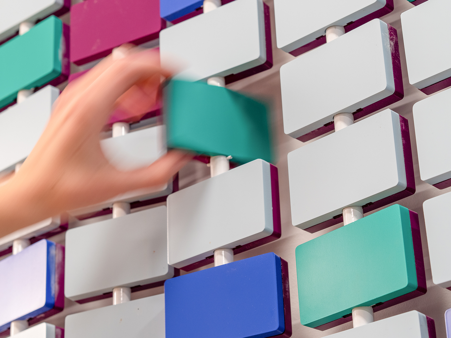 Detail image of interactive wall graphic, featuring colorful rotating blocks