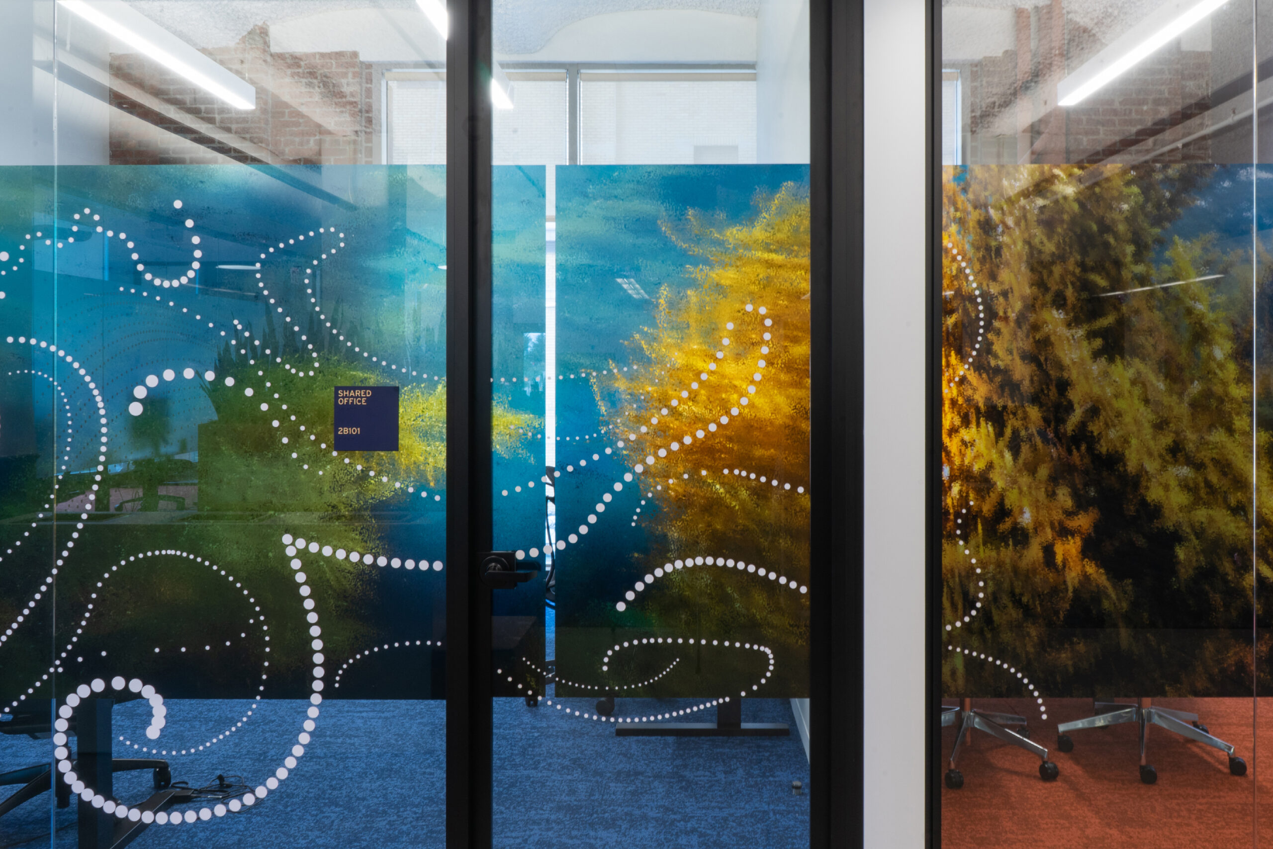 Glass graphics with an ocean scene and coral with a dot pattern overlaid